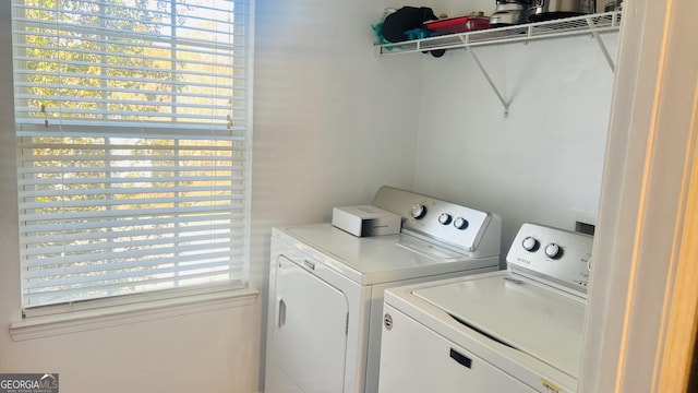 clothes washing area featuring separate washer and dryer