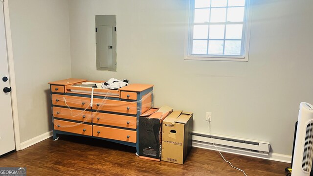 interior space featuring baseboard heating, dark wood-type flooring, and electric panel