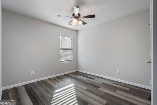 empty room featuring dark wood-style floors, ceiling fan, and baseboards