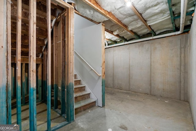 unfinished basement featuring stairs