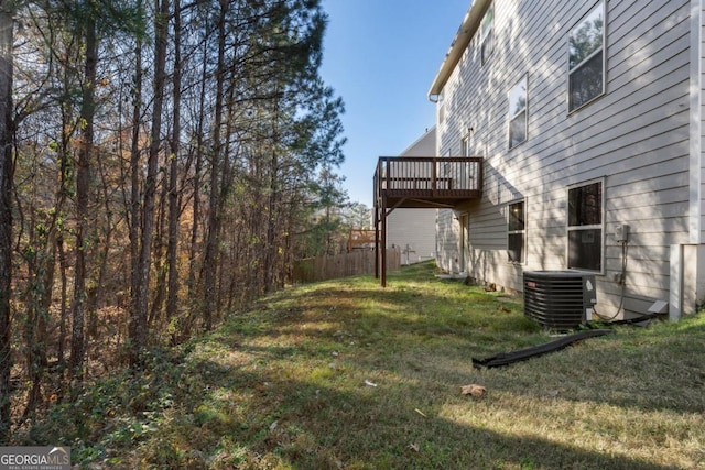 view of yard featuring cooling unit, fence, and a deck