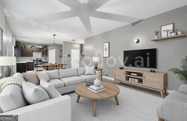 living area featuring baseboards and wood finished floors