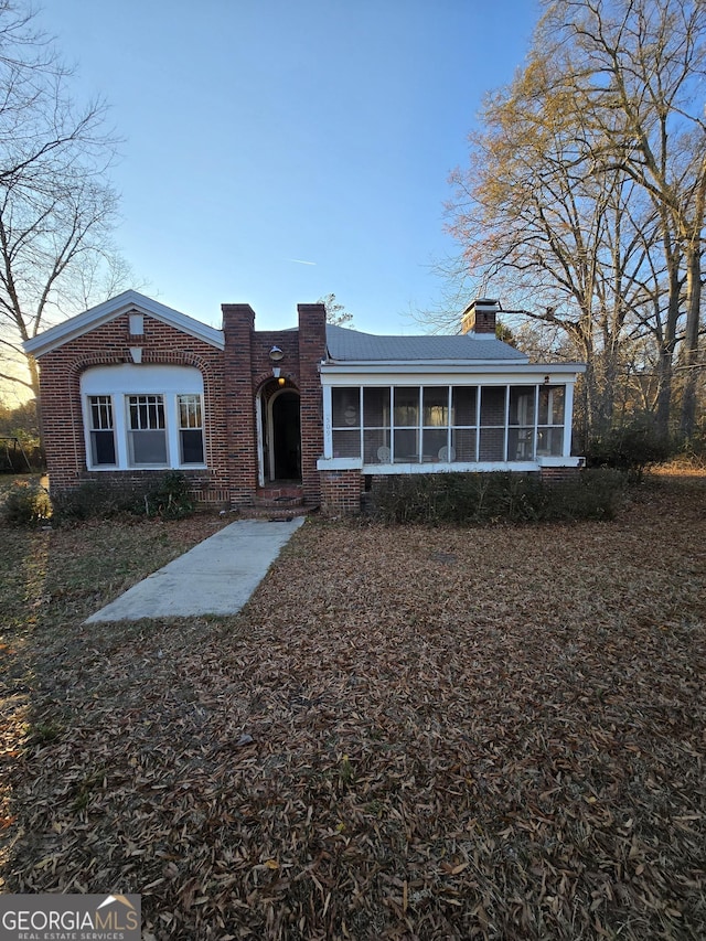 view of front facade with a sunroom