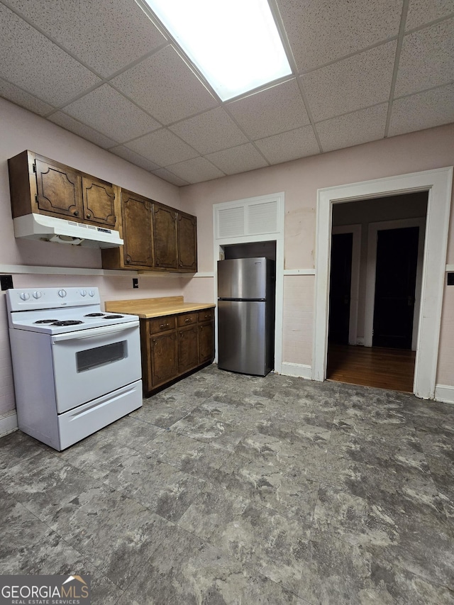 kitchen with stainless steel refrigerator, electric range, and dark brown cabinets