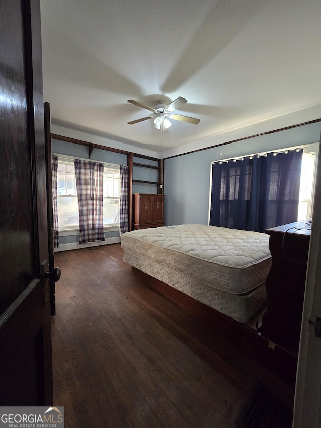 bedroom with ceiling fan and dark wood-type flooring