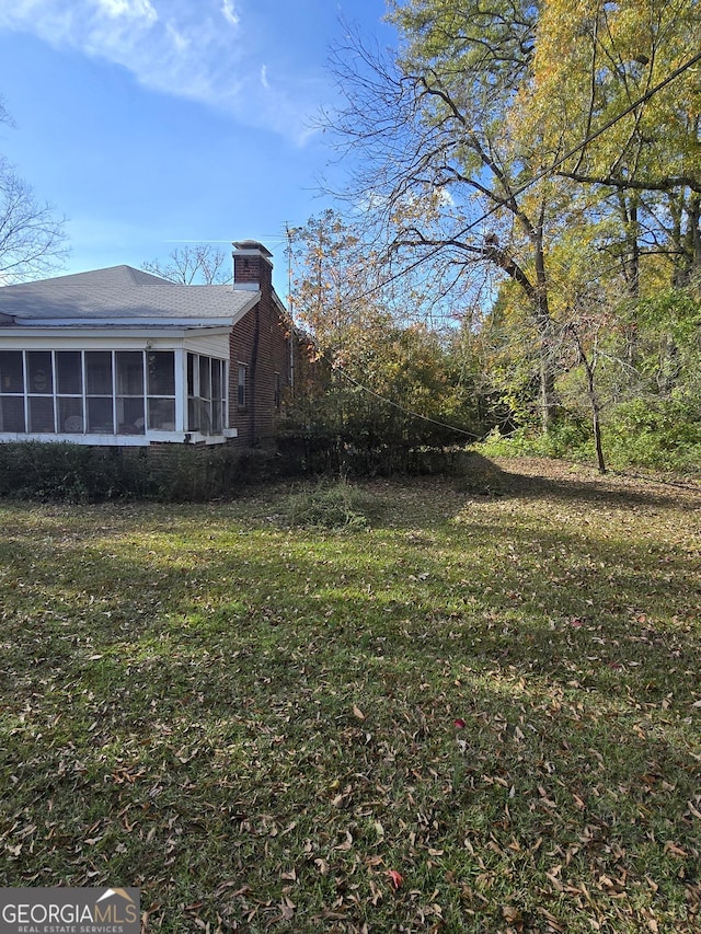 view of yard featuring a sunroom