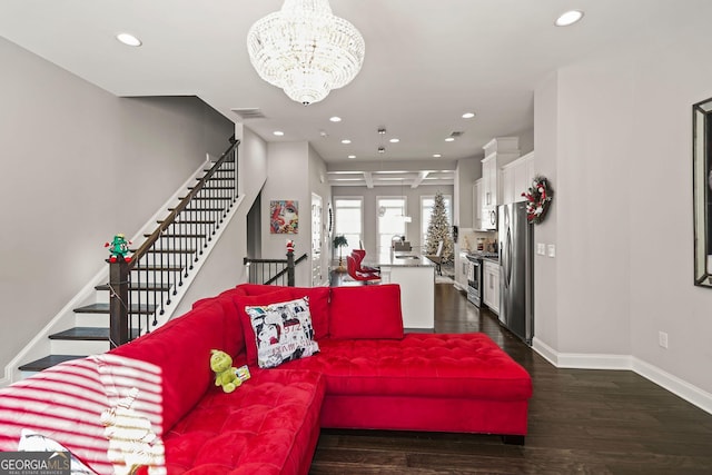 living room with dark hardwood / wood-style floors, an inviting chandelier, and sink