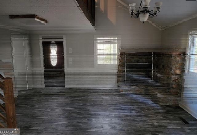 interior space featuring a chandelier, wood-type flooring, and vaulted ceiling