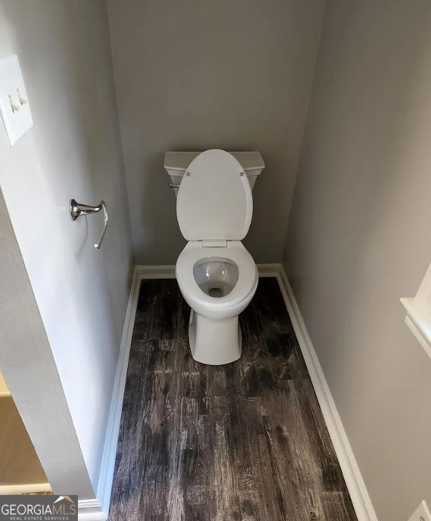 bathroom featuring hardwood / wood-style flooring and toilet