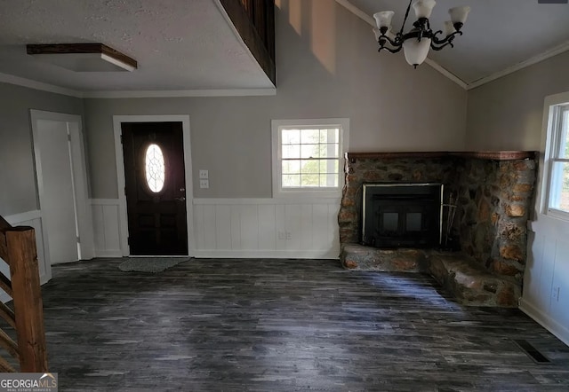 entryway with vaulted ceiling, dark hardwood / wood-style floors, and ornamental molding