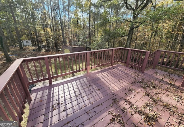 wooden terrace with a shed