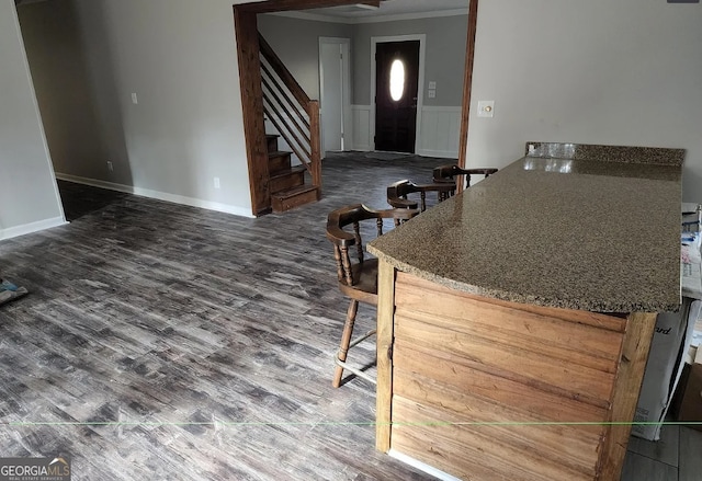 kitchen with hardwood / wood-style flooring and crown molding