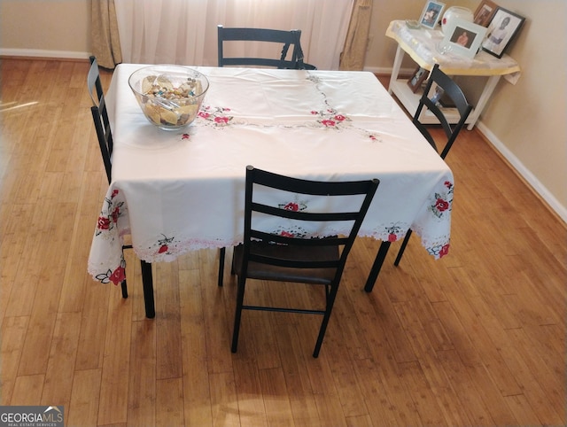 dining area with hardwood / wood-style flooring