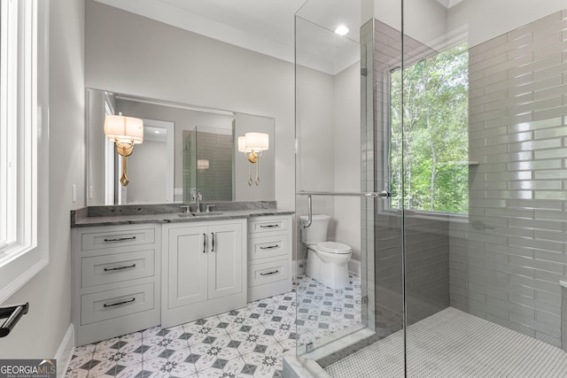 bathroom with vanity, baseboards, a stall shower, and toilet