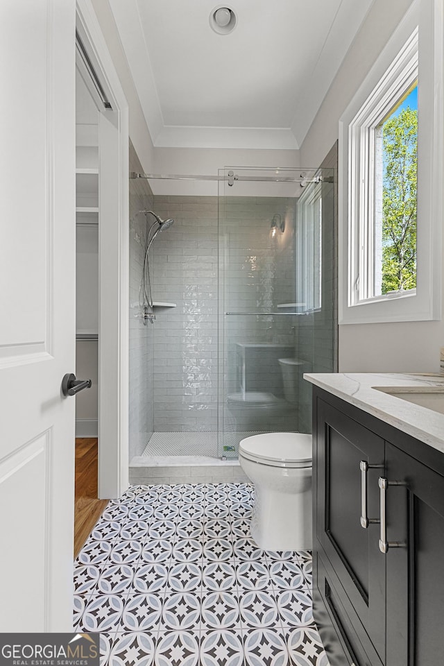 bathroom with vanity, tile patterned floors, a stall shower, and toilet