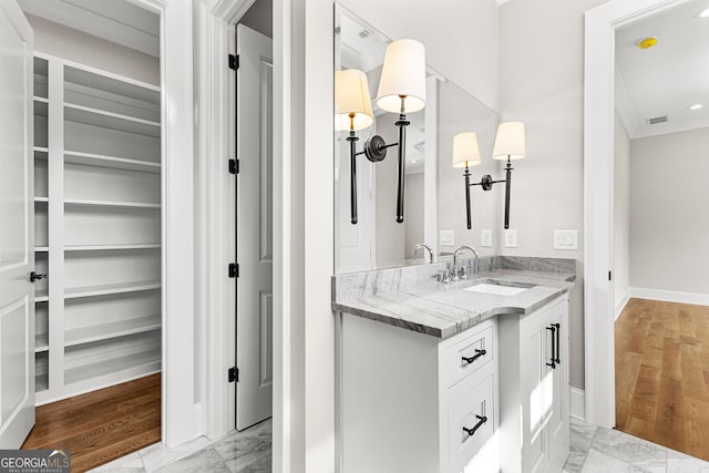 bathroom featuring visible vents, vanity, baseboards, marble finish floor, and recessed lighting