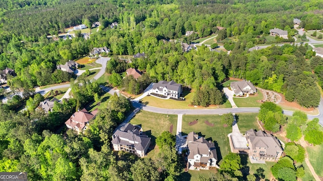 bird's eye view featuring a residential view and a wooded view
