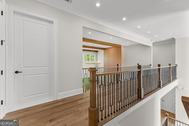 corridor featuring recessed lighting, an upstairs landing, and wood finished floors