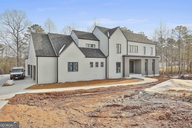 back of house featuring a garage