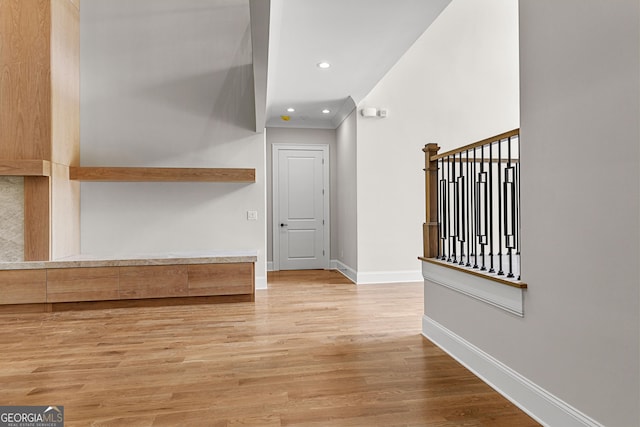 entrance foyer with recessed lighting, baseboards, and wood finished floors