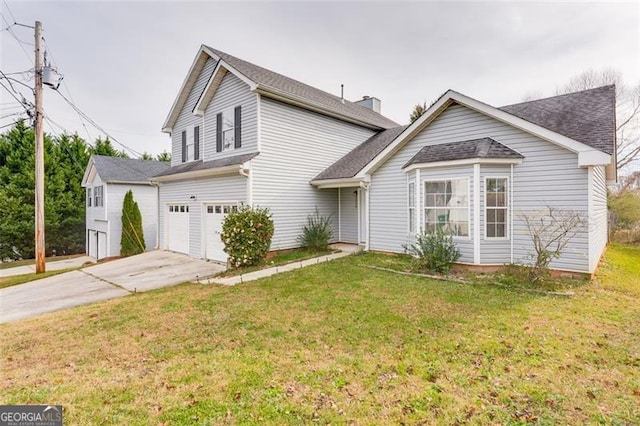 view of property featuring a front yard and a garage