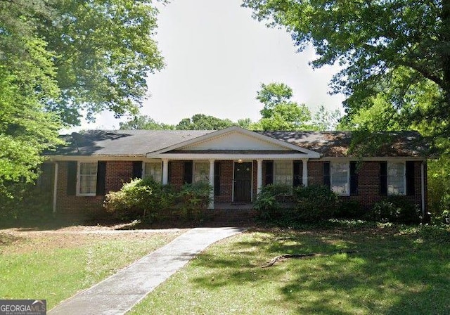 ranch-style home featuring a front yard