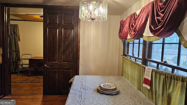 dining room featuring a notable chandelier and dark wood-type flooring