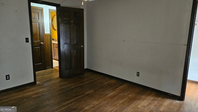 unfurnished bedroom with dark wood-type flooring