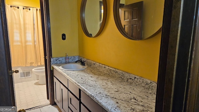 bathroom featuring vanity, tile patterned floors, and toilet