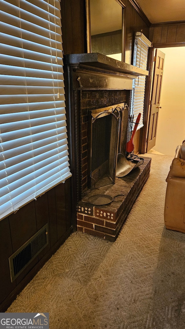 interior space featuring a brick fireplace, carpet flooring, and wooden walls