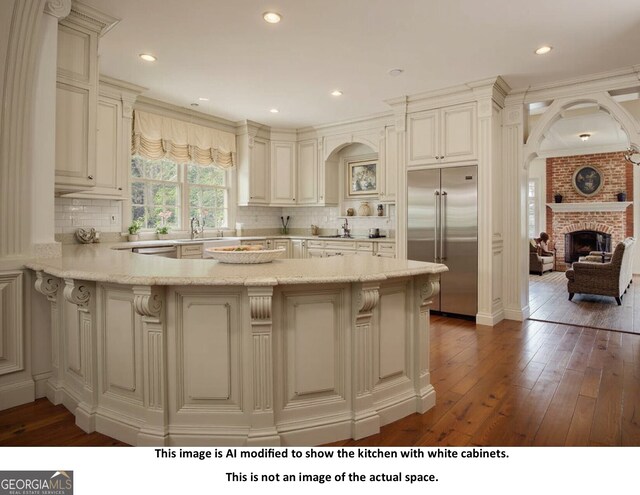 kitchen featuring stainless steel appliances, light hardwood / wood-style flooring, tasteful backsplash, and sink