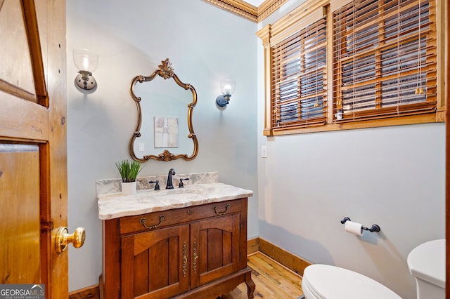 bathroom featuring hardwood / wood-style flooring, vanity, and toilet