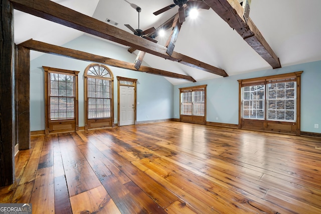 unfurnished living room featuring hardwood / wood-style flooring, ceiling fan, beam ceiling, and high vaulted ceiling