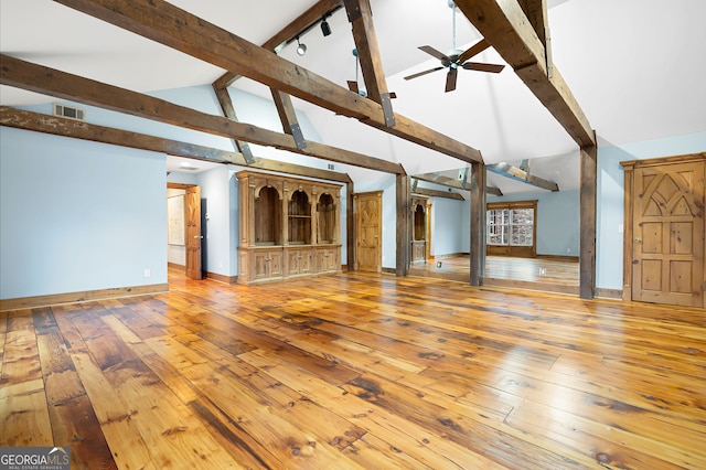 unfurnished living room with hardwood / wood-style flooring, ceiling fan, and high vaulted ceiling