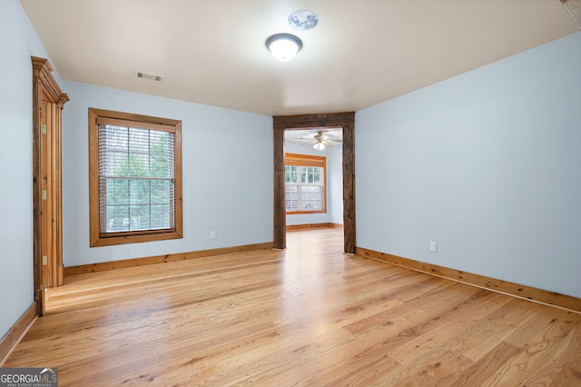 unfurnished room with ceiling fan, plenty of natural light, and light hardwood / wood-style floors