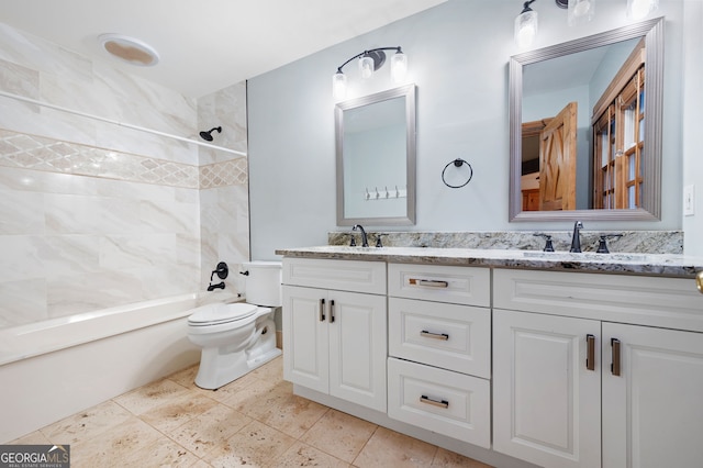 full bathroom featuring vanity, toilet, and tiled shower / bath