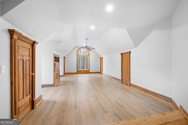 additional living space featuring ceiling fan, light wood-type flooring, and vaulted ceiling