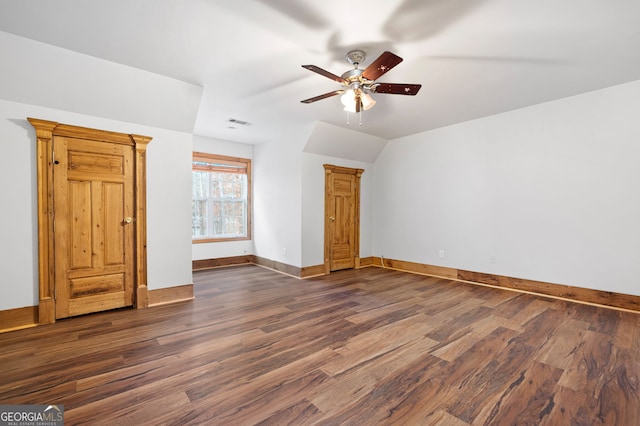 interior space with lofted ceiling, ceiling fan, and dark hardwood / wood-style floors