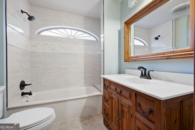 full bathroom featuring vanity, tiled shower / bath combo, toilet, and a wealth of natural light