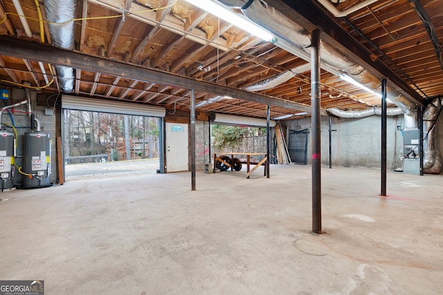 basement featuring heating unit, gas water heater, and water heater