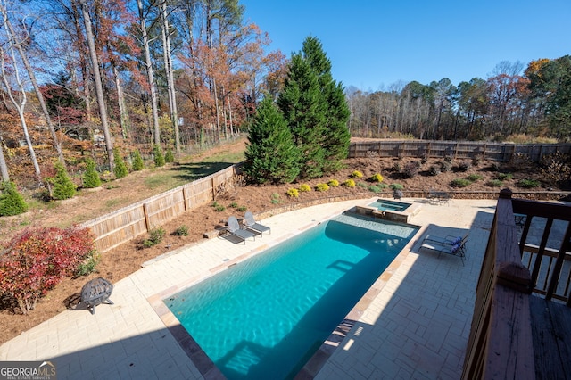 view of swimming pool with an in ground hot tub and a patio area