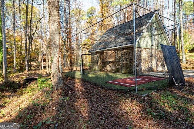 view of yard featuring tennis court and basketball court