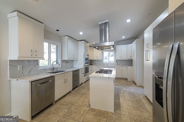 kitchen with island exhaust hood, a center island, stainless steel appliances, and white cabinets