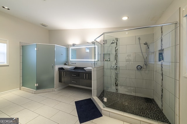 bathroom featuring tile patterned flooring, vanity, and an enclosed shower