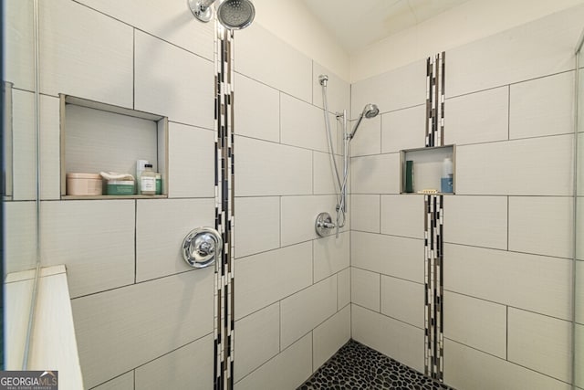 bathroom with a tile shower