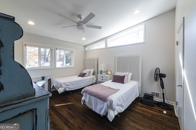 bedroom with vaulted ceiling, ceiling fan, and dark wood-type flooring