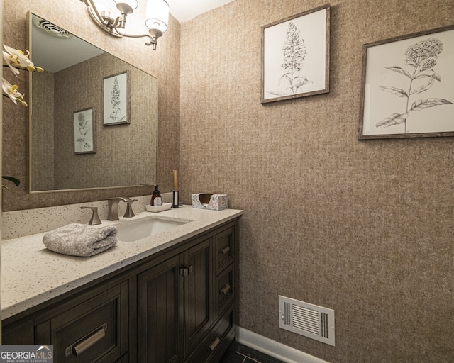 bathroom featuring a chandelier and vanity