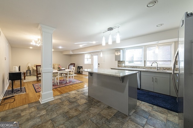 kitchen with a kitchen island, plenty of natural light, dark wood-type flooring, and sink