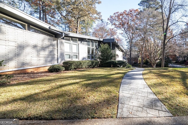 view of side of property with a yard