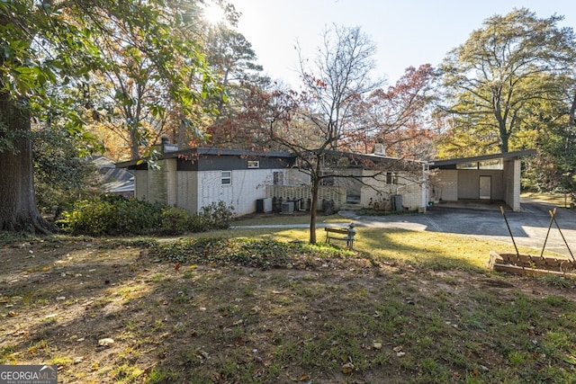 view of front facade with central air condition unit and a carport